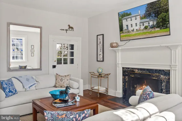 a living room with furniture a lamp and a window