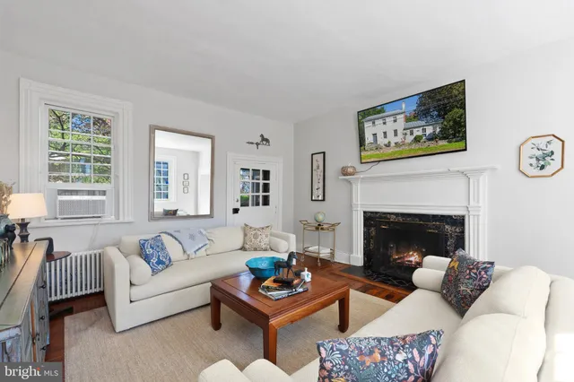 a living room with lots of furniture and a book shelf