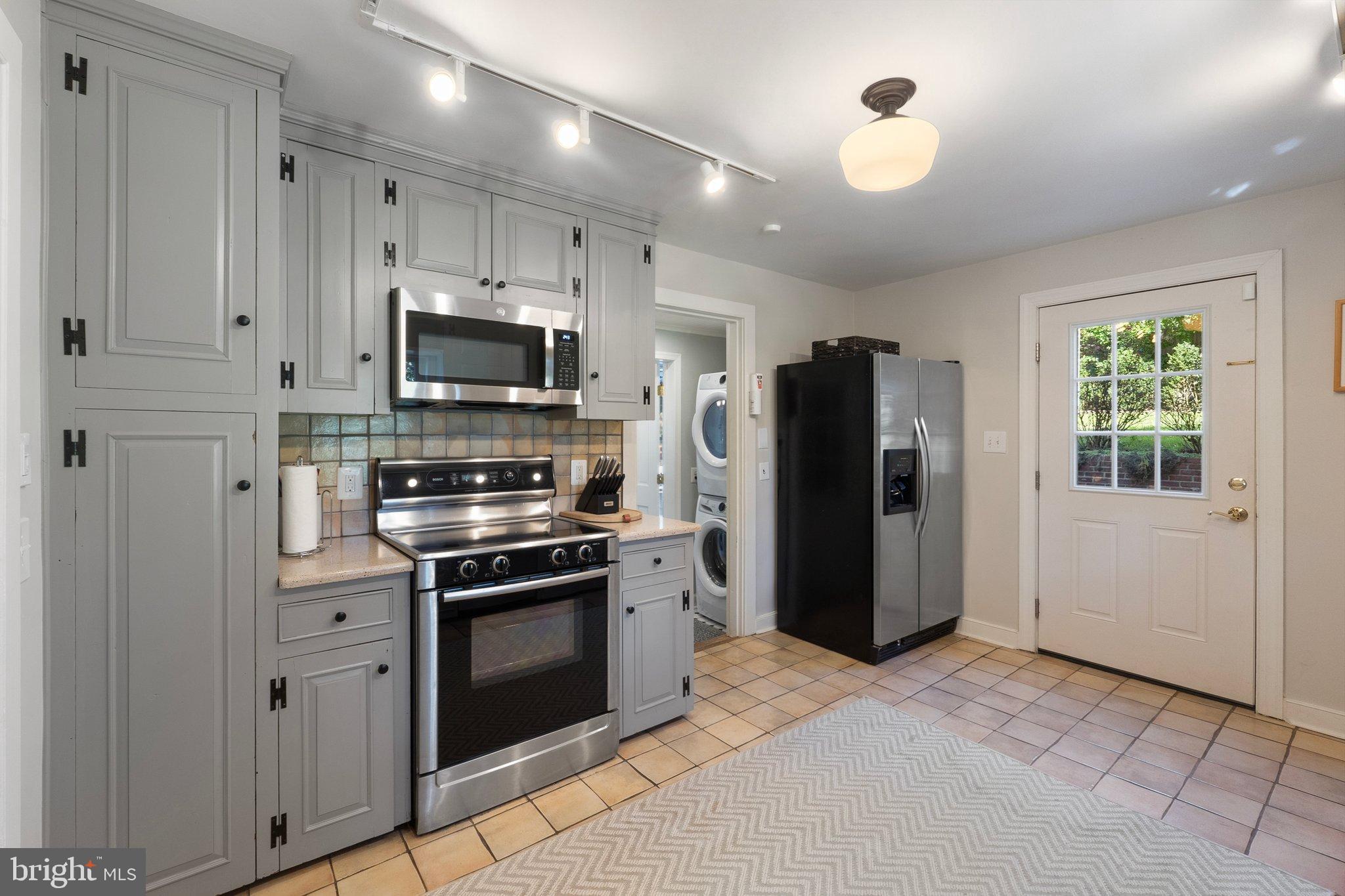 677 Federal Street Paris, VA 20130 - Photo 29 of 82 Modern kitchen with sleek gray cabinetry.