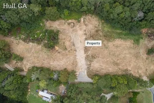 an aerial view of a residential houses with outdoor space and street view