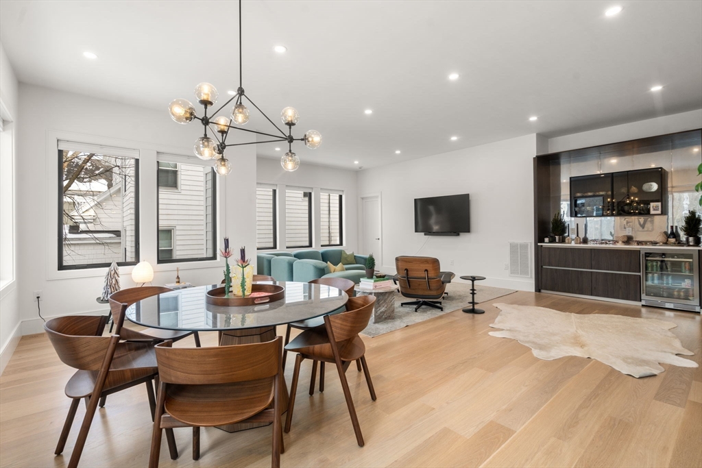116 Thorndike Street, Unit 1 Brookline, MA 02446 - Photo 11 of 16 a view of a dining room with furniture window and wooden floor