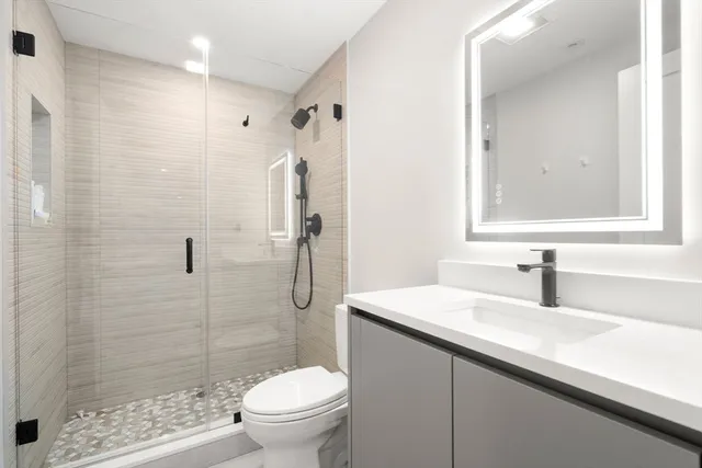 a bathroom with a sink toilet and shower