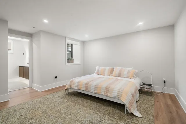 a bedroom with a bed and painting on the wall