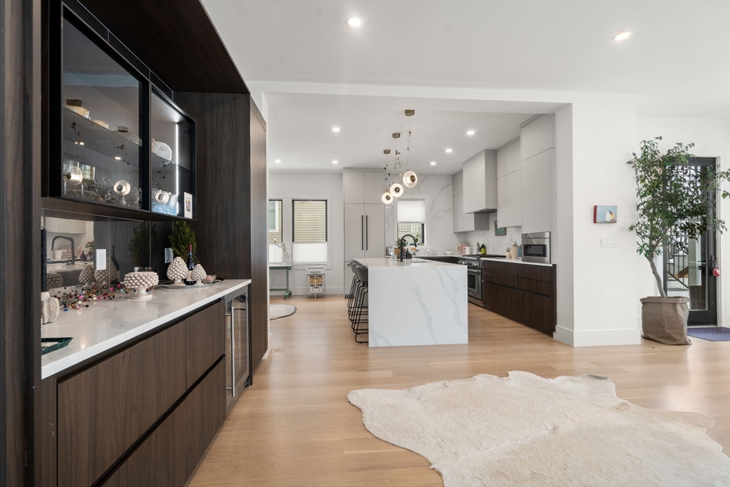 116 Thorndike Street, Unit 1 Brookline, MA 02446 - Photo 5 of 16 a large white kitchen with a large counter top appliances and cabinets