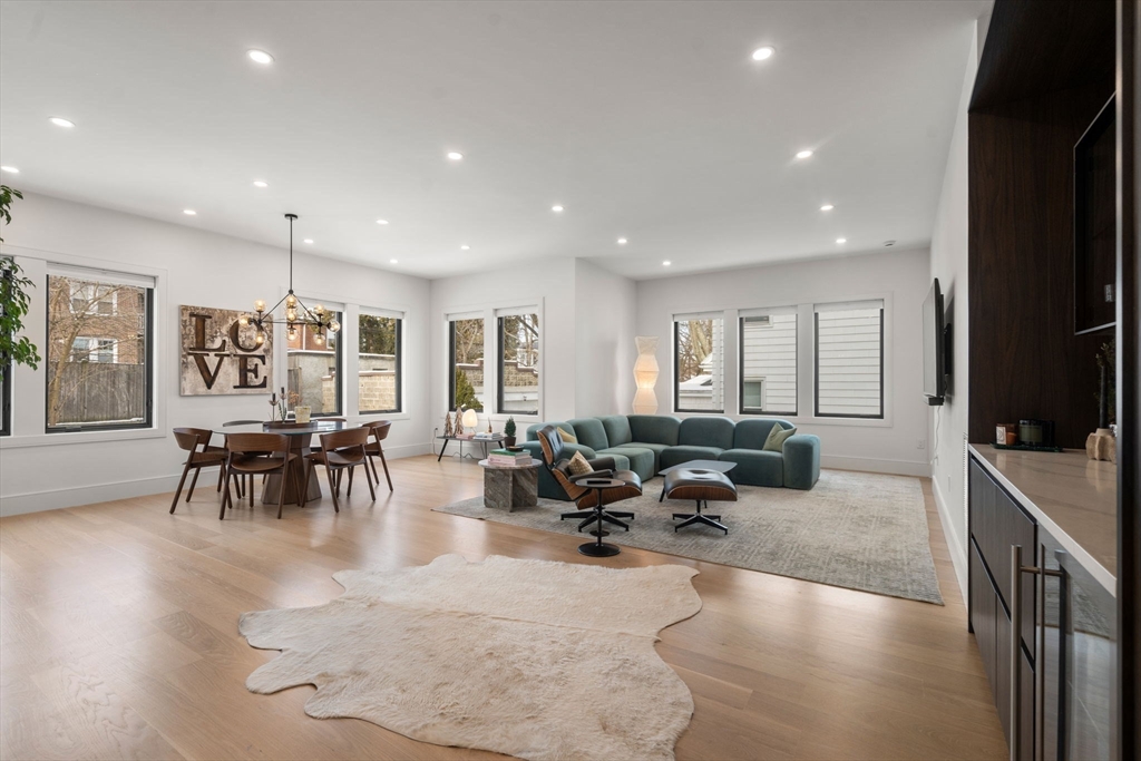 116 Thorndike Street, Unit 1 Brookline, MA 02446 - Photo 7 of 16 a living room with furniture and wooden floor