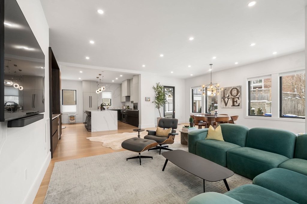 116 Thorndike Street, Unit 1 Brookline, MA 02446 - Photo 9 of 16 a living room with furniture and wooden floor