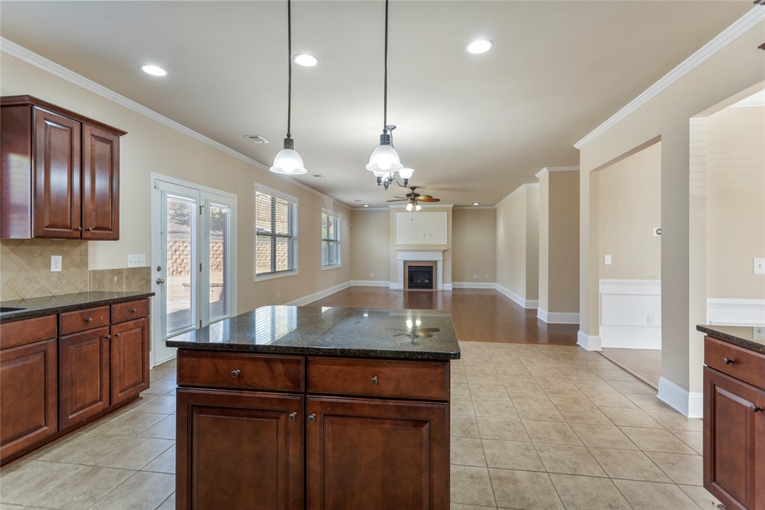 1005 Winmar Drive Anderson, SC 29621 - Photo 18 of 50 This inviting space features a kitchen island, fireplace, and ample natural light, perfect for gatherings.