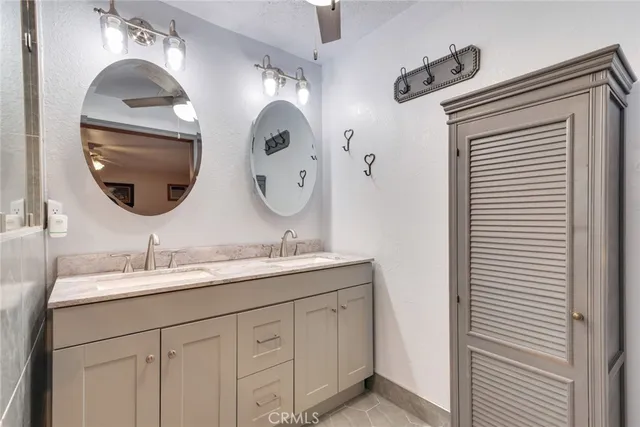 a bathroom with a double vanity sink and a mirror