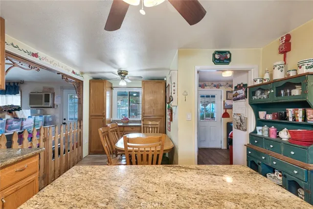 a room with lots of wooden furniture and a chandelier