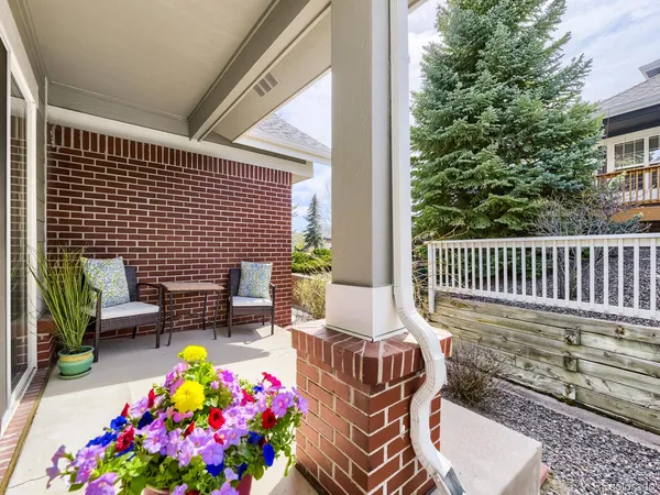 a view of a chairs and table in the back yard of the house