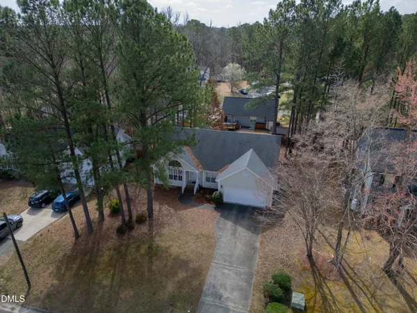 a view of a house with a yard and sitting area