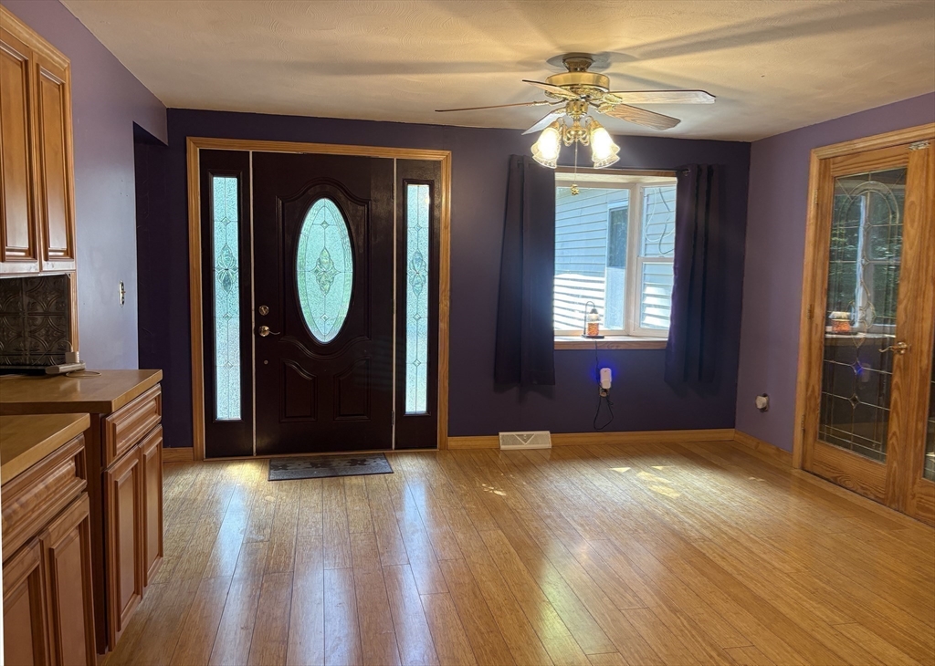 88 Colby Drive Halifax, MA 02338 - Photo 16 of 38 a view of a hallway with wooden floor and a chandelier