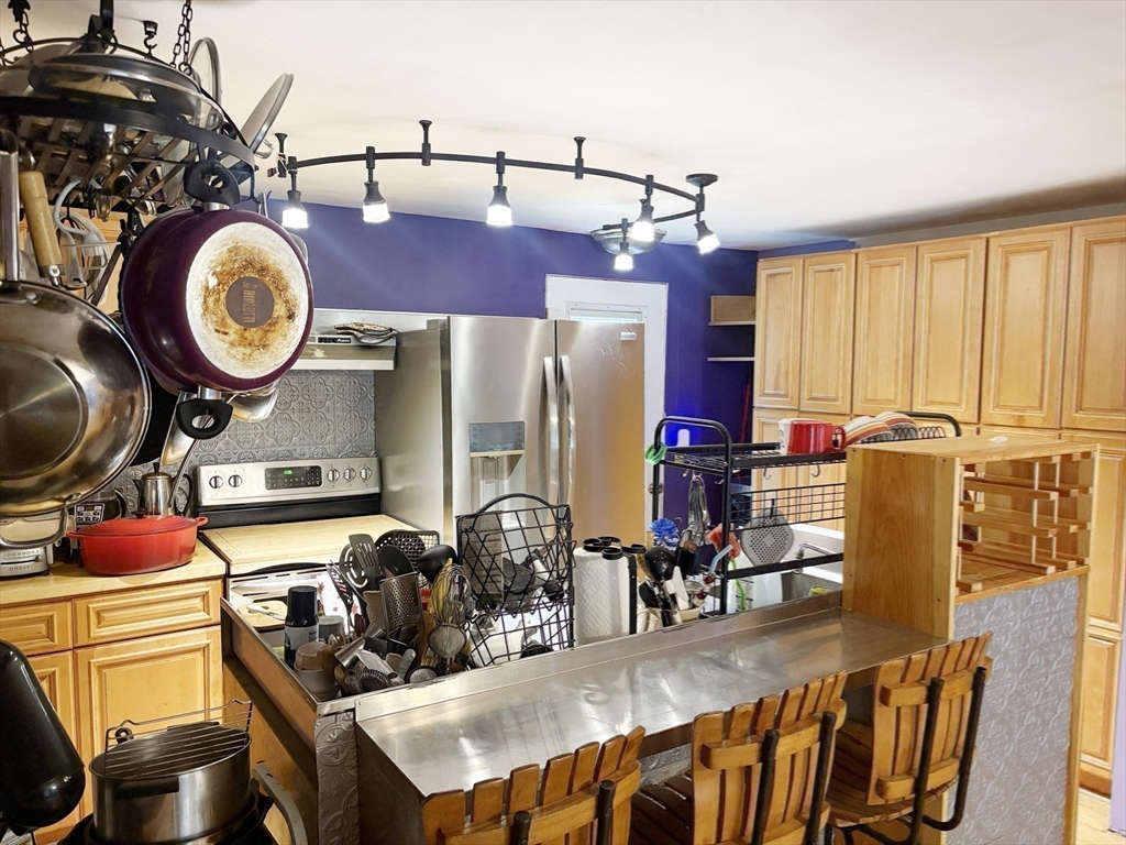88 Colby Drive Halifax, MA 02338 - Photo 19 of 38 a kitchen with stainless steel appliances granite countertop a sink a stove and a wooden cabinets
