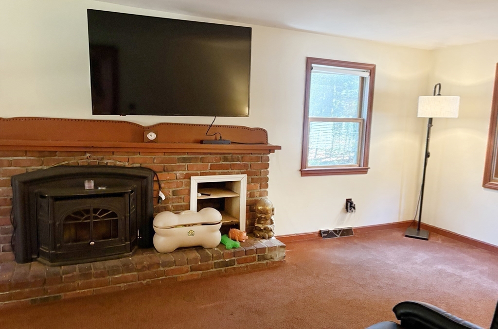 88 Colby Drive Halifax, MA 02338 - Photo 23 of 38 a living room with furniture and a fireplace