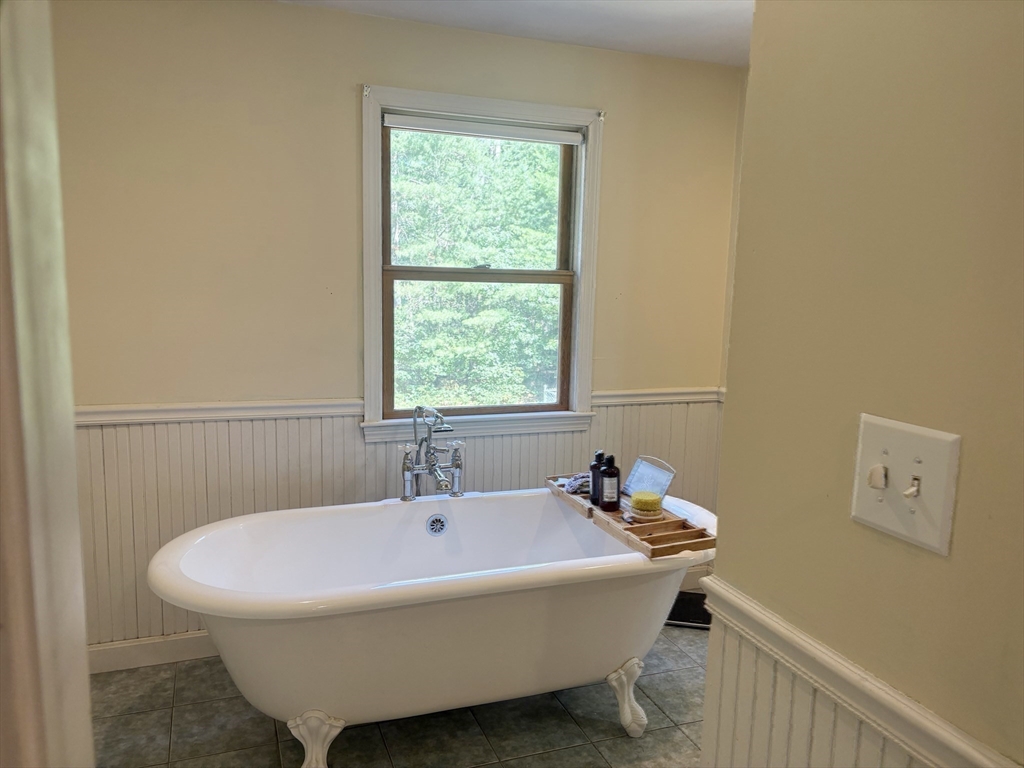 88 Colby Drive Halifax, MA 02338 - Photo 28 of 38 a white bath tub sitting next to a window