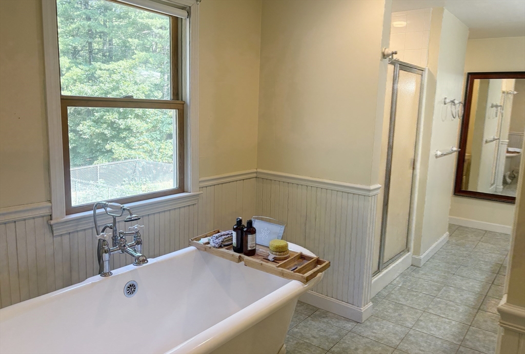 88 Colby Drive Halifax, MA 02338 - Photo 29 of 38 a bathroom with a tub and a window