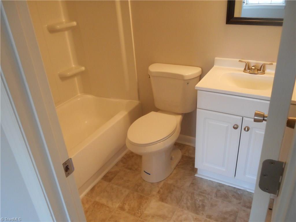 5725 Bramblegate Road, Unit F Greensboro, NC 27409 - Photo 17 of 30 Master Bathroom: Room features include new vinyl flooring for easy cleaning, fresh new paint, new toilet, vanity and fixtures.