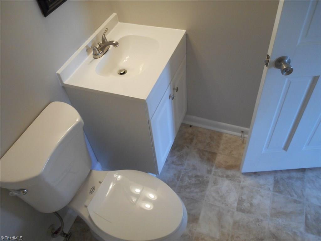 5725 Bramblegate Road, Unit F Greensboro, NC 27409 - Photo 18 of 30 Master Bathroom: Room features include new vinyl flooring for easy cleaning, fresh new paint, new toilet, vanity and fixtures.