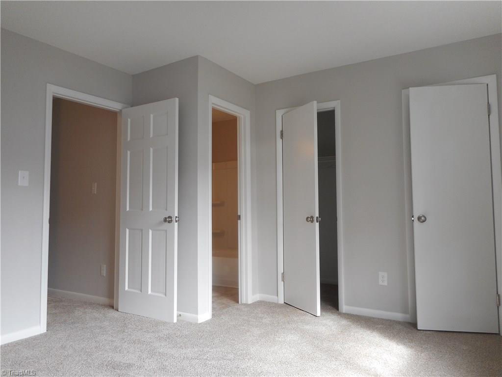 5725 Bramblegate Road, Unit F Greensboro, NC 27409 - Photo 20 of 30 Bedroom Two: Room features include fresh new paint, two windows for natural lighting, new carpet flooring and your own private full size bathroom. The door on the left side is to the main hall, the door in the middle is to your bathroom and the two open doors on the right are for your full length closet