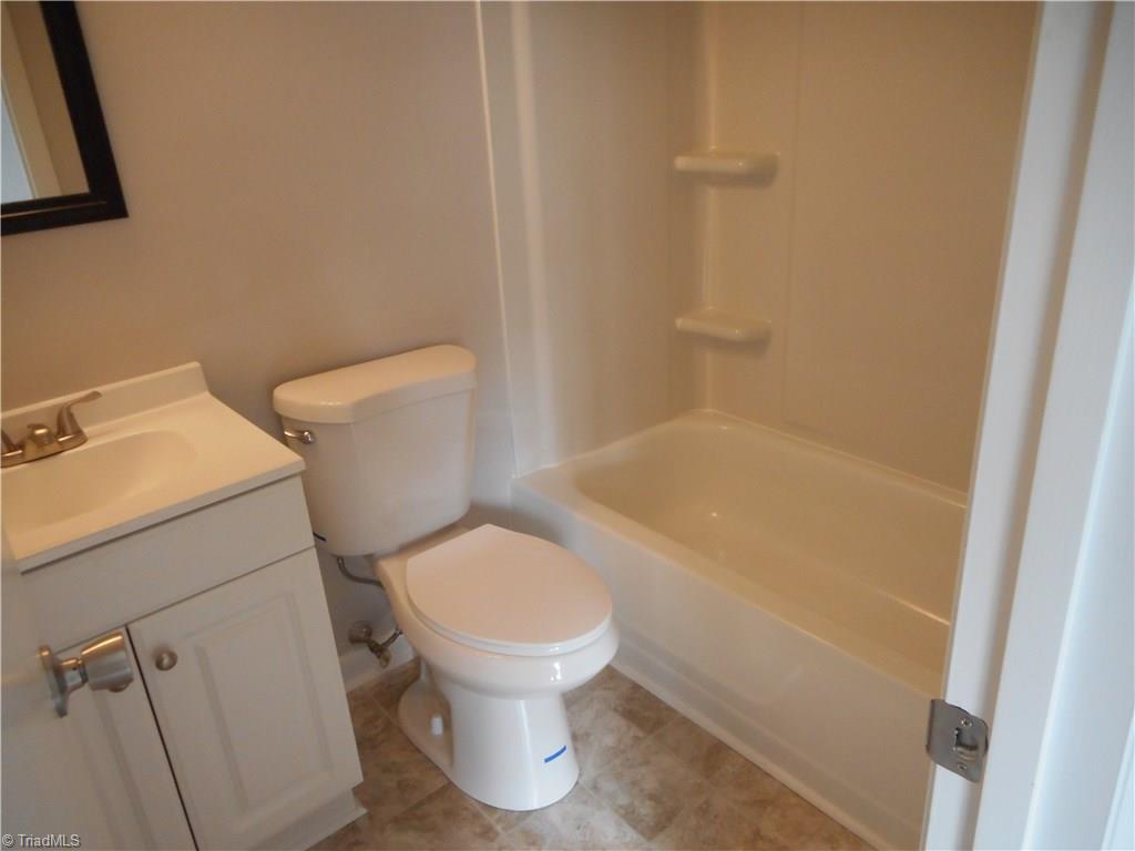 5725 Bramblegate Road, Unit F Greensboro, NC 27409 - Photo 23 of 30 Bedroom Two Bathroom: Room features include New Vinyl Flooring for easy cleaning, Fresh new paint, New vanity, top and fixtures. This is also a full bathroom.