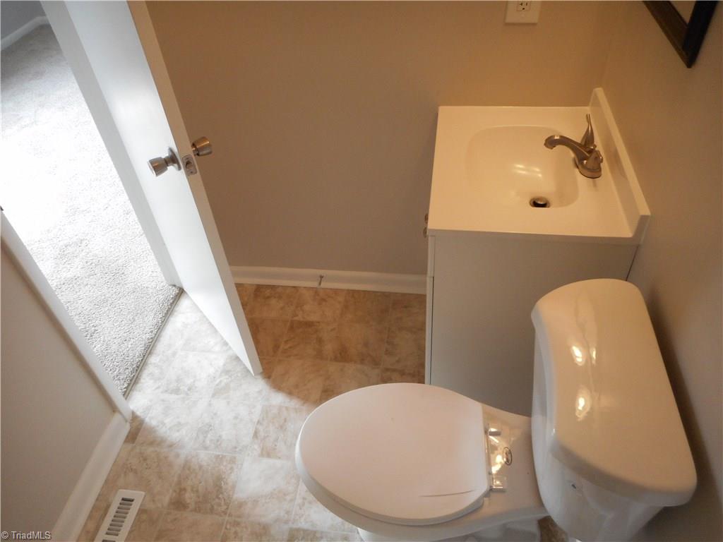 5725 Bramblegate Road, Unit F Greensboro, NC 27409 - Photo 24 of 30 Bedroom Two Bathroom: Room features include New Vinyl Flooring for easy cleaning, Fresh new paint, New vanity, top and fixtures. The open door is to bedroom two.