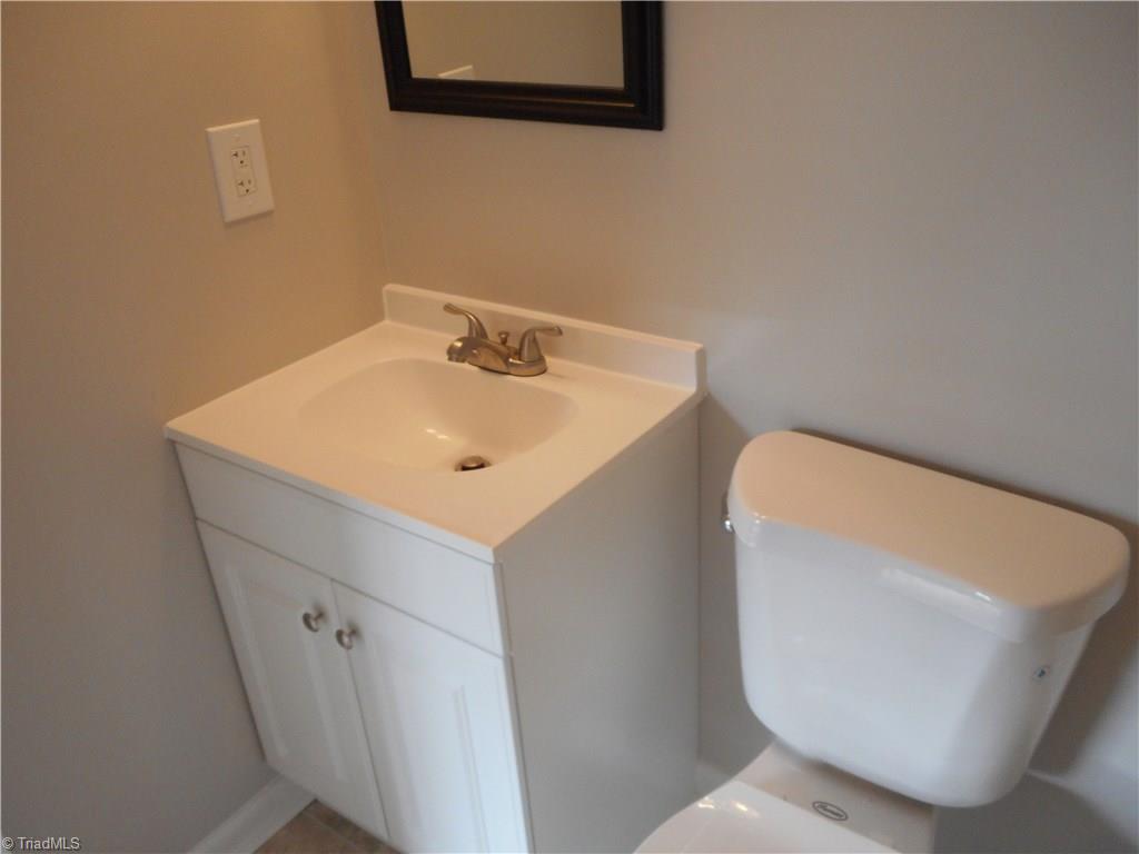 5725 Bramblegate Road, Unit F Greensboro, NC 27409 - Photo 25 of 30 Bedroom Two Bathroom: Room features include New Vinyl Flooring for easy cleaning, Fresh new paint, New vanity, top and fixtures. This is also a full bathroom.
