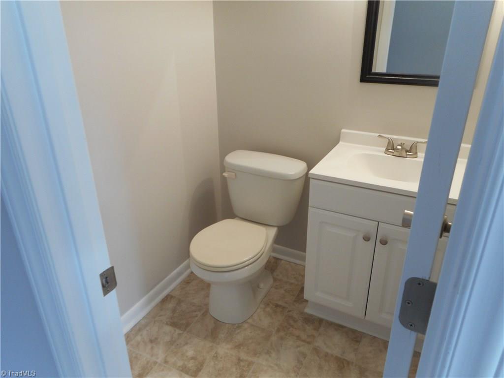 5725 Bramblegate Road, Unit F Greensboro, NC 27409 - Photo 26 of 30 Main Level Half Bathroom: Room features include new vinyl flooring for easy cleaning, fresh new paint and new vanity, top and fixtures.