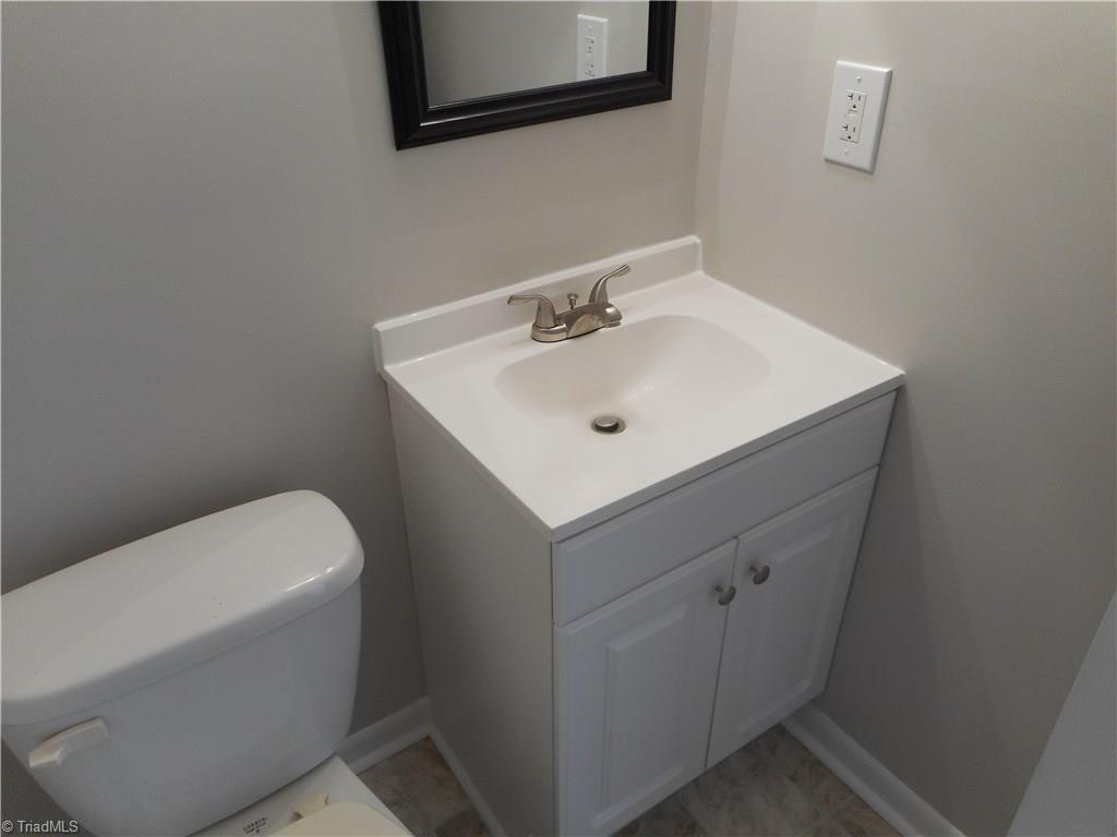 5725 Bramblegate Road, Unit F Greensboro, NC 27409 - Photo 27 of 30 Main Level Half Bathroom: Room features include new vinyl flooring for easy cleaning, fresh new paint and new vanity, top and fixtures.