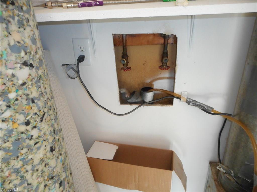 5725 Bramblegate Road, Unit F Greensboro, NC 27409 - Photo 29 of 30 Laundry Room: Room features new vinyl flooring for easy cleaning and fresh new paint. Here we can see the hookup for the washer. The furnace is on the right side for easy access.
