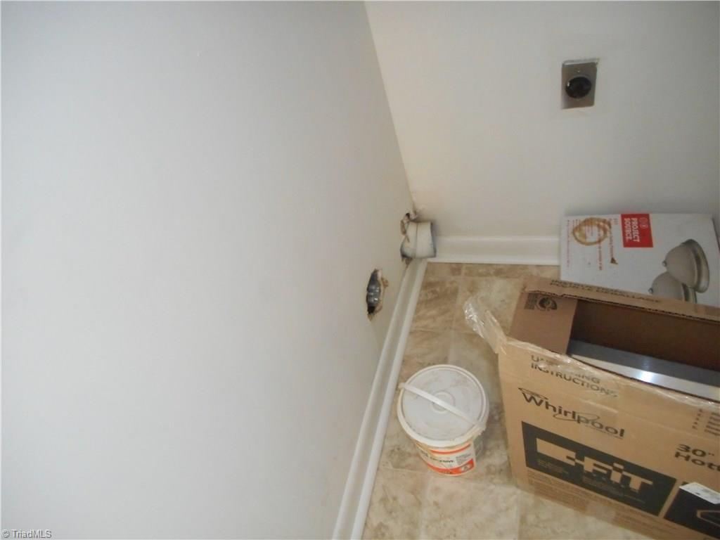 5725 Bramblegate Road, Unit F Greensboro, NC 27409 - Photo 30 of 30 Laundry Room: Room features new vinyl flooring for easy cleaning and fresh new paint. Here we can see the hookup for the dryer. The furnace is on the right side for easy access.