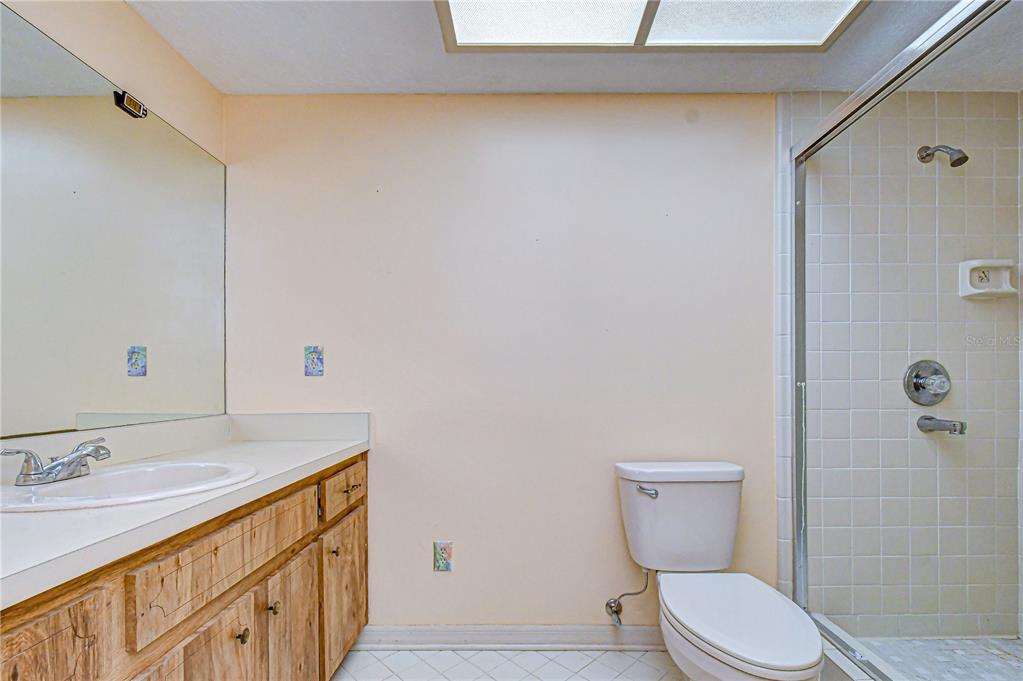 2608 Bellwood Drive Brandon, FL 33511 - Photo 19 of 27 a bathroom with a granite countertop sink toilet and shower