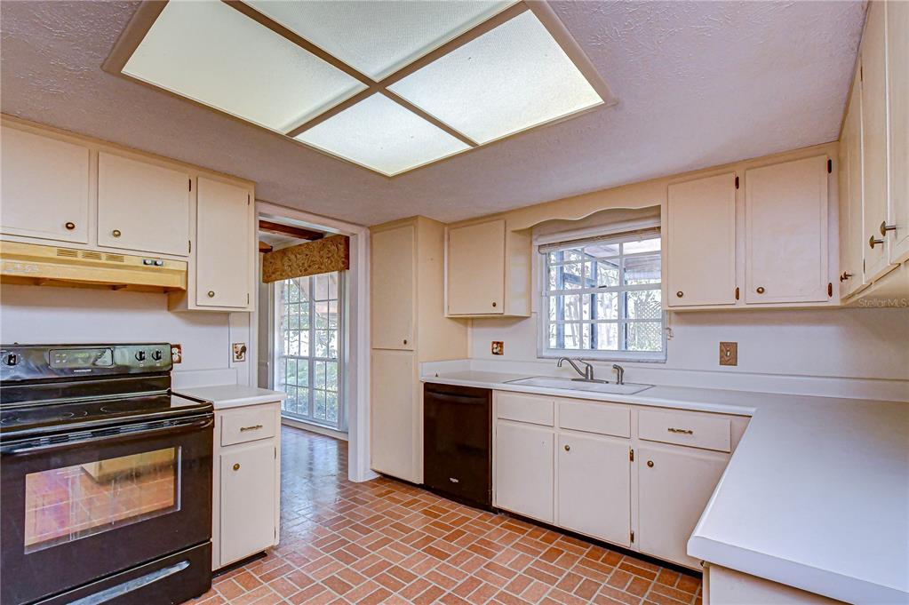 2608 Bellwood Drive Brandon, FL 33511 - Photo 5 of 27 a kitchen with a sink stove and cabinets