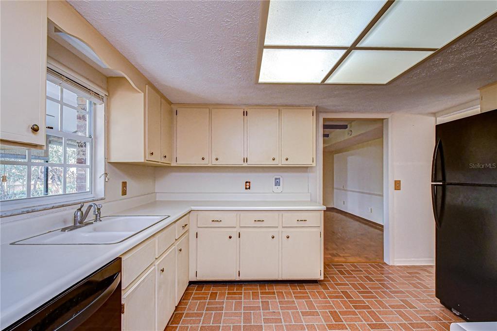 2608 Bellwood Drive Brandon, FL 33511 - Photo 6 of 27 a kitchen with a sink a refrigerator and cabinets