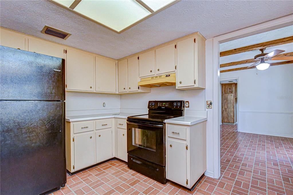 2608 Bellwood Drive Brandon, FL 33511 - Photo 7 of 27 a kitchen with stainless steel appliances granite countertop a stove a sink and a refrigerator