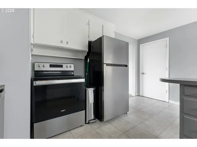 a kitchen with cabinets and stainless steel appliances