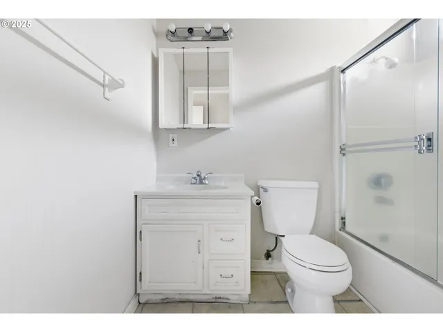 a view of an empty room and wooden floor