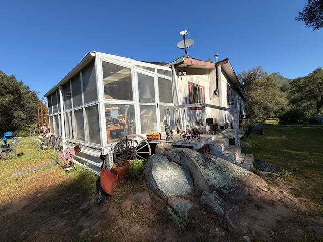 4565 Morgan Road Angels Camp, CA 95222 - Photo 12 of 43 view of side of property featuring a sunroom and a yard