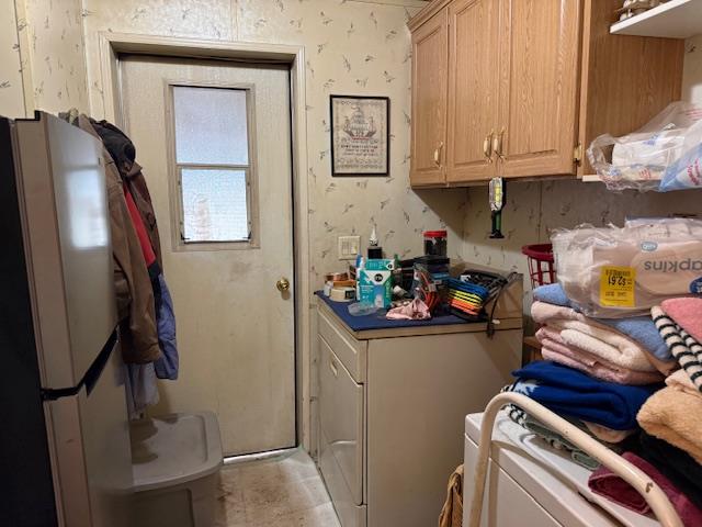 4565 Morgan Road Angels Camp, CA 95222 - Photo 34 of 43 laundry area with wallpapered walls, cabinet space, and washing machine and dryer