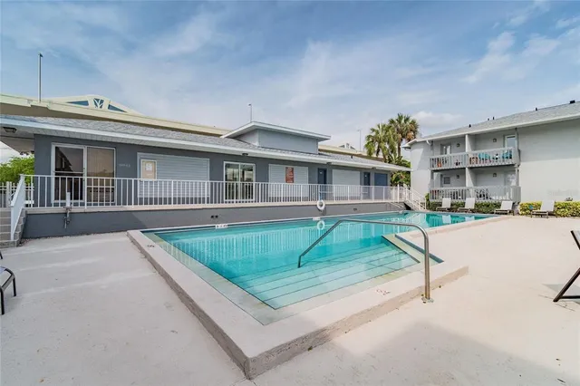a swimming pool with outdoor seating and yard