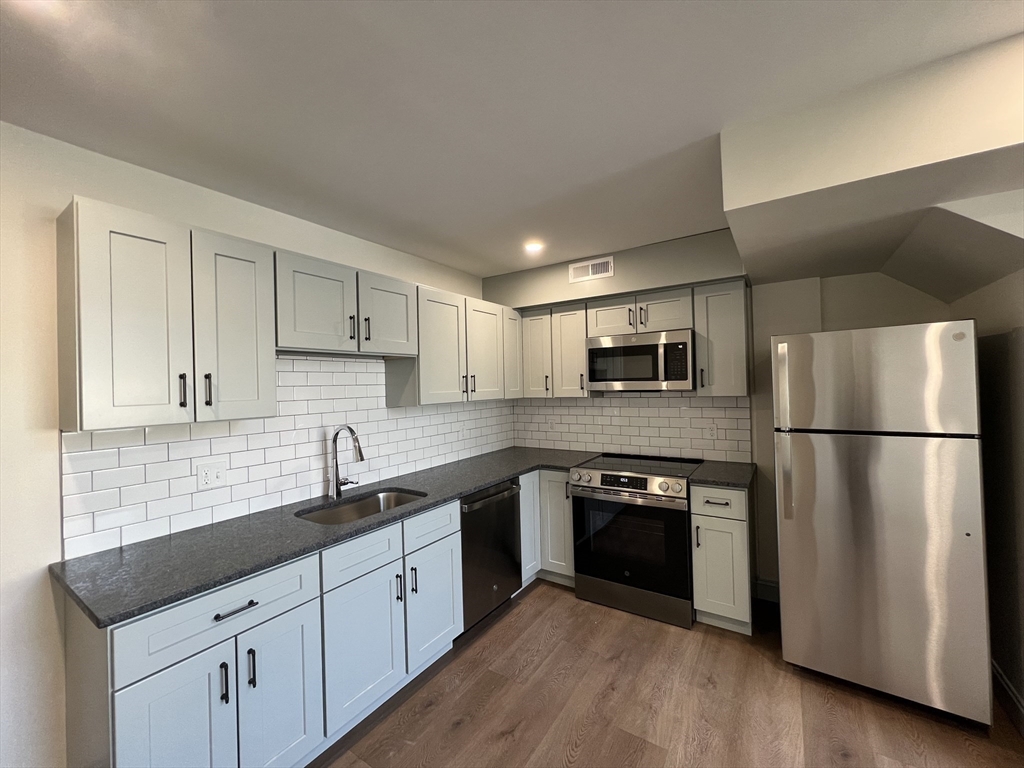 160 Seabury Street, Unit 42 Fall River, MA 02720 - Photo 2 of 10 a kitchen with stainless steel appliances a refrigerator sink and microwave
