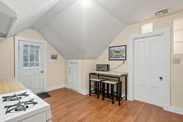 a view of a workspace with furniture and wooden floor