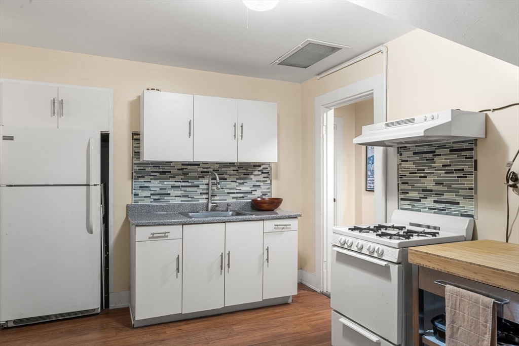 21 Wenham Street, Unit 3 Boston, MA 02130 - Photo 13 of 21 a kitchen with a stove and a refrigerator