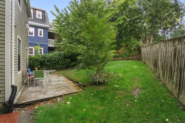 a view of a brick building next to a big yard