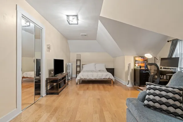 a bedroom with furniture and a flat screen tv