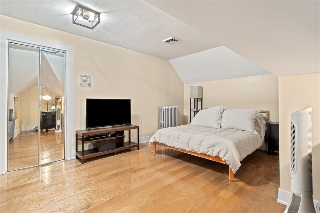 21 Wenham Street, Unit 3 Boston, MA 02130 - Photo 3 of 21 a spacious bedroom with a bed and a flat screen tv