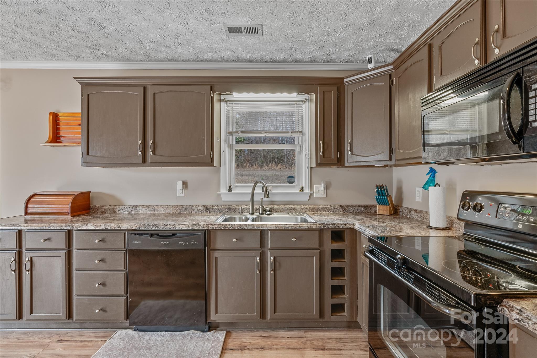 242 Maple Creek Road Rutherfordton, NC 28139 - Photo 13 of 37 a kitchen with a sink stove top oven and cabinets