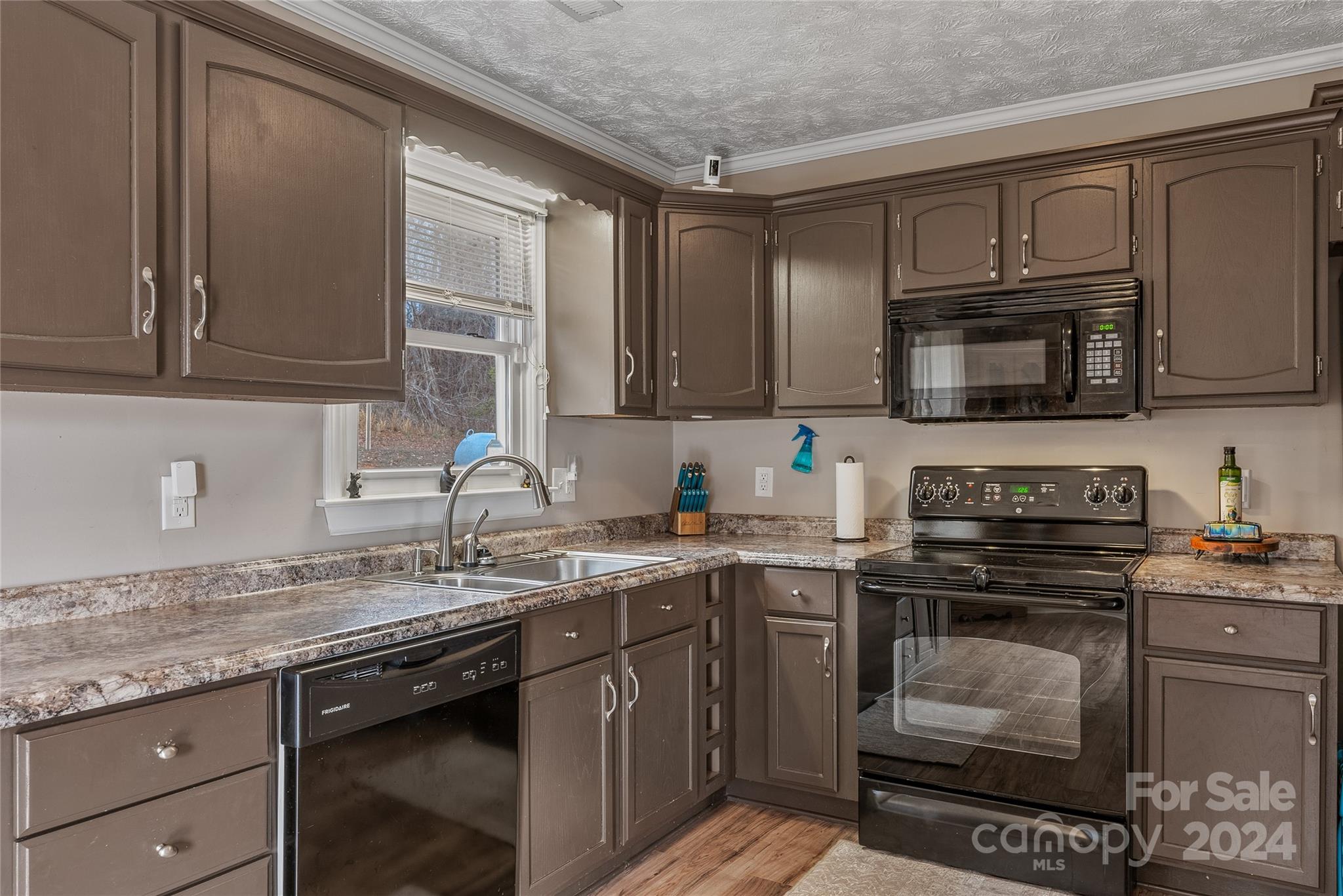 242 Maple Creek Road Rutherfordton, NC 28139 - Photo 18 of 37 a kitchen with granite countertop a sink stove and cabinets