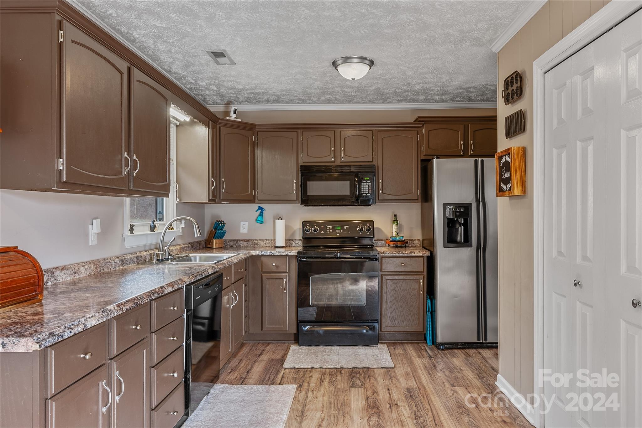 242 Maple Creek Road Rutherfordton, NC 28139 - Photo 21 of 37 a kitchen with stainless steel appliances granite countertop a refrigerator a stove top oven a sink and dishwasher