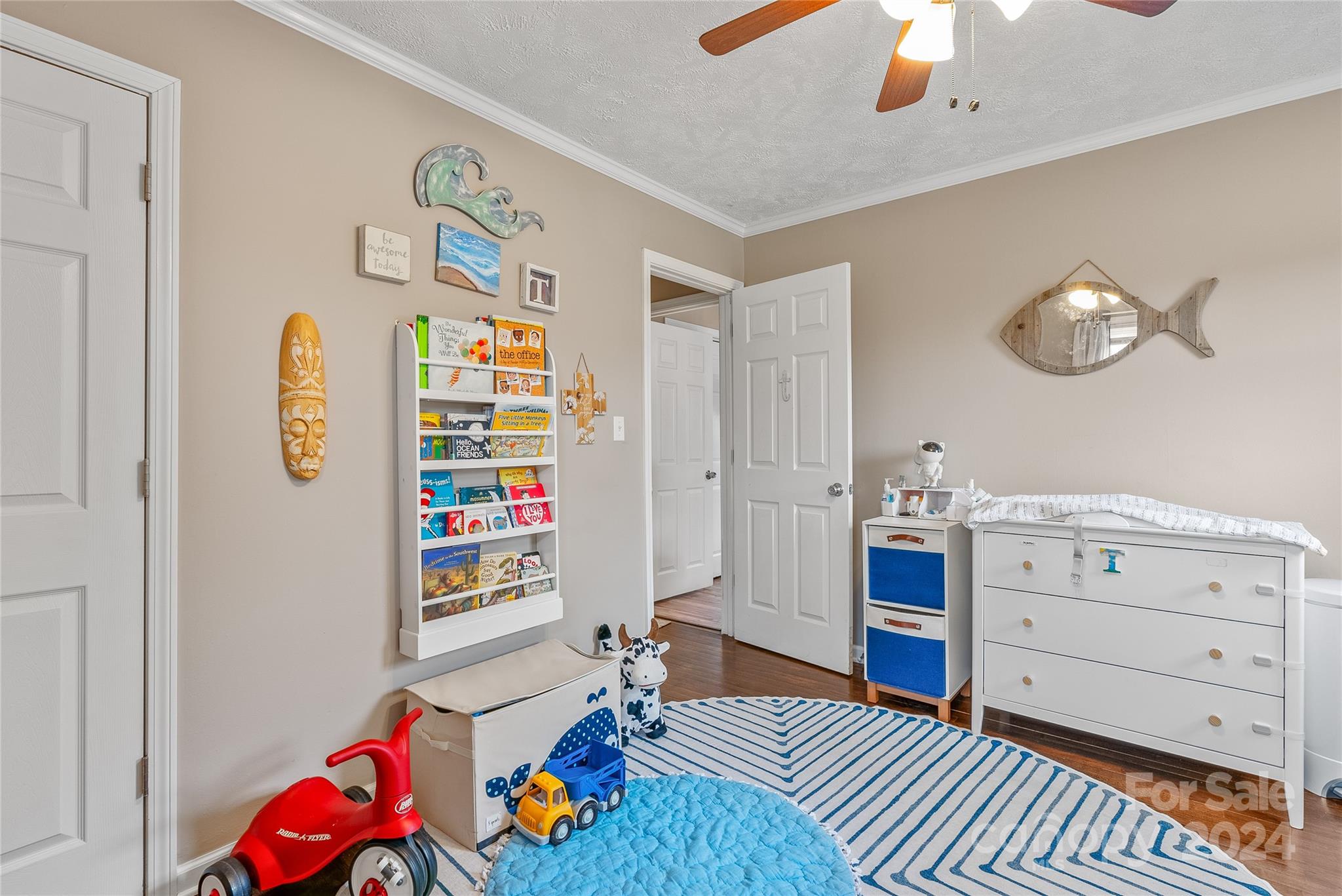 242 Maple Creek Road Rutherfordton, NC 28139 - Photo 22 of 37 a bedroom with a bed and a chandelier