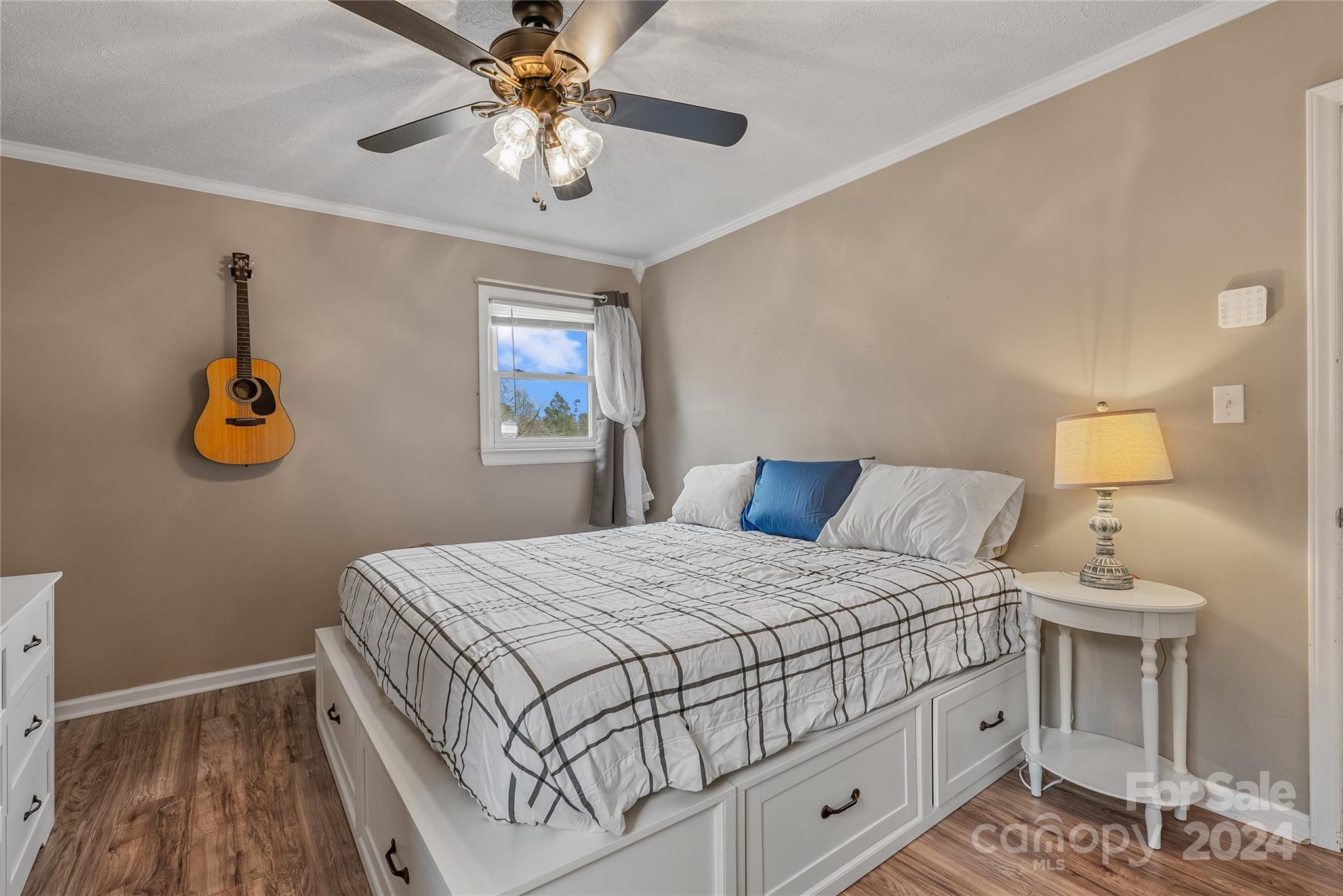 242 Maple Creek Road Rutherfordton, NC 28139 - Photo 27 of 37 a bedroom with a bed and a table with a chandelier